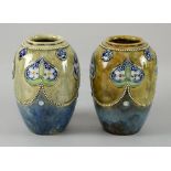 Pair of Doulton Stoneware vases, with Art Nouveau style decoration of inverted hearts with flowers