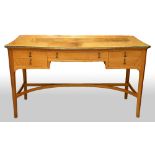 Edward Barnsley, 1900-1987, walnut serpentine fronted desk with central drawer flanked by two