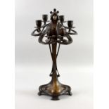 Art Nouveau style bronze candlestick bears signature Erte,Paris on base. In the form of a maiden