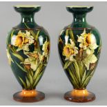 A pair of early 20th C Doulton Lambeth Faience vases, hand painted with daffodils, painted