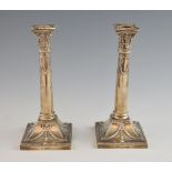 Pair of Edward VII silver Corinthian column candlesticks on square bases, by Mappin & Webb,