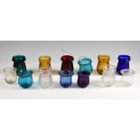 Collection of early 20th century clear and coloured glass Christmas tree candle holders,