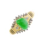 A jade and diamond dress ring. The freeform jadeite cabochon, with brilliant-cut diamond sides and