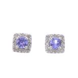 A pair of tanzanite and diamond cluster earrings. Each of square-shape outline, with a circular-