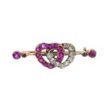A late Victorian gold synthetic ruby and diamond double heart brooch, circa 1890. The interlinked
