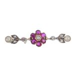 A ruby, diamond and spilt pearl brooch. The split pearl and cushion-shape ruby floral cluster,