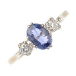 An 18ct gold sapphire and diamond three-stone ring. The oval-shape sapphire, with brilliant-cut