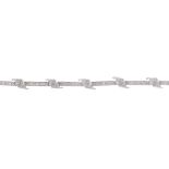 An 18ct gold diamond bracelet. Designed as a series of pave-set diamond bars, with similarly-set