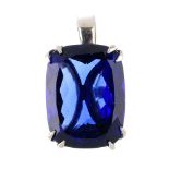 A tanzanite pendant. The rectangular cushion-shape tanzanite, weighing 55.39cts, within an