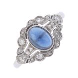 A mid 20th century sapphire and diamond ring. The oval sapphire cabochon, with single and rose-cut