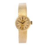 OMEGA - a lady's De Ville bracelet watch. Yellow metal case, stamped 18K 0.750 with poincon.