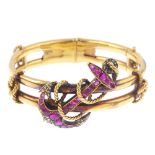 A mid Victorian 18ct gold, ruby and diamond bangle, circa 1870. Of openwork design, the cushion-