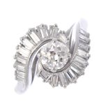 A diamond dress ring. The circular-cut diamond, with graduated baguette-cut diamond asymmetric