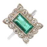 An early 20th century emerald and diamond cluster ring. The rectangular-shape emerald, within a
