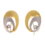 A pair of 18ct gold diamond earrings. Each designed as a brilliant-cut diamond collet, within bi-