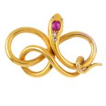 An early 20th century gold gem-set snake pendant. The coiled snake, with cushion-shape ruby and