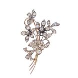 An early 20th century diamond floral spay brooch. With old and rose-cut diamond floral and foliate