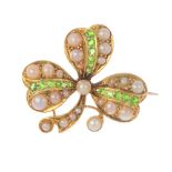 An early 20th century 15ct gold demantoid garnet and split pearl brooch. The split pearl clover,
