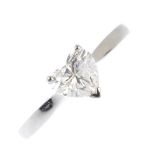 A platinum diamond single-stone ring. The heart-shape diamond, weighing 0.90ct, with tapered