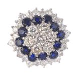An 18ct gold sapphire and diamond cluster ring. Of hexagonal outline, the brilliant-cut diamond