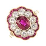 A mid 20th century Burma ruby and diamond cluster ring. The oval-shape Burma ruby, with circular-cut