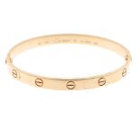 CARTIER - a 'Love' bangle. The polished bangle, with screw head motifs. Signed and numbered Cartier,