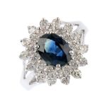 A 9ct gold sapphire and diamond cluster ring. The oval-shape sapphire, with brilliant-cut diamond