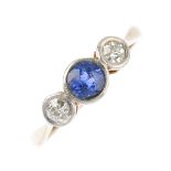 An early 20th century gold sapphire and diamond three-stone ring. The circular-shape sapphire