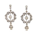 A pair of diamond earrings. Each designed as an old and single-cut diamond drop, suspended from a