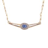 A sapphire and diamond necklace. The oval sapphire cabochon and single-cut diamond cluster, with