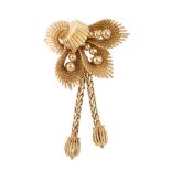 A 1960s 9ct gold spray brooch. The grooved and textured spray brooch, with graduated gold bead