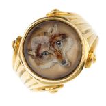 A fox ring. The painted fox head, within the rock crystal cabochon, with scroll and grooved