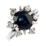 A 1970s 14ct gold sapphire and diamond ring. The oval-shape sapphire, within a stylised star and