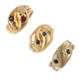 Three 9ct gold snake rings. Each designed as two overlapping serpent heads, with sapphire, green