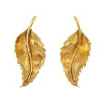 A pair of 18ct gold earrings. Each designed as a textured leaf. Import marks for Birmingham, 1964.