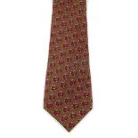 HERMÈS - a silk tie. The brown tie with a burgundy coloured galloping reindeer motif. Length