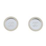 CHANEL - a pair of ear clips. Each designed as a circular mirrored panel with centrally engraved