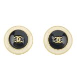 CHANEL - a pair of ear clips. Each designed as circular panels, with raised central black enamel