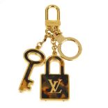 LOUIS VUITTON - a Porte Cles Confidence key holder and bag charm. Designed as a padlock and key,