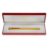 CARTIER - a Must De Cartier ballpoint pen. Designed in an oblong shape, with brushed gold-tone