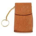 CHANEL - a caviar leather phone case. Crafted from tan grained caviar leather, featuring a raised CC