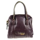 CHLOÉ - an Eclipse handbag. Designed with a glazed dark purple leather exterior and gold-tone