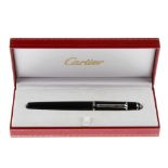 CARTIER - a ballpoint pen. With black enamel body, silver-tone banding and clip with personal