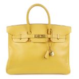 HERMÈS - a limited edition Jaune d'Or Courchevel Birkin 35 handbag. Crafted from golden yellow,