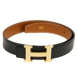 HERMÈS - a Constance H buckle belt. Crafted from smooth black leather with the reverse a tan Epson