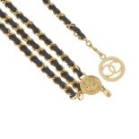 CHANEL - a chain belt. Designed as a gold-tone curb-link chain, interwoven with black leather,