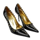 DOLCE & GABBANA - a pair of black patent leather spike stilettos. Designed with a pointed toe,