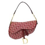 CHRISTIAN DIOR - a pink canvas saddle handbag. Featuring maker's signature monogram canvas