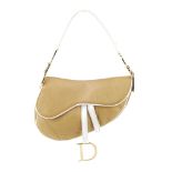 CHRISTIAN DIOR - a beige saddle handbag. Featuring a beige exterior and white leather trim, with a