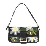 FENDI - a denim daisy baguette handbag. Designed with a dark blue denim exterior featuring mesh